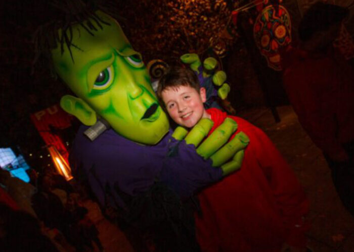 Boy Hugging Green Frankenstein Monster Costume At Night