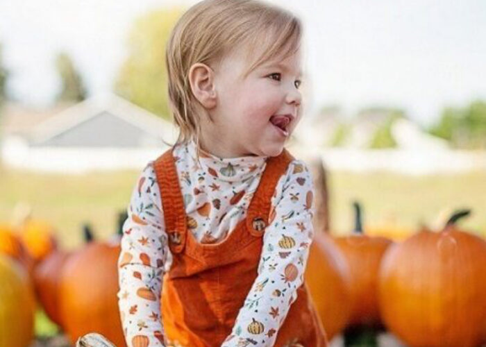 Smiling Young Girl In Pumpkin Patch