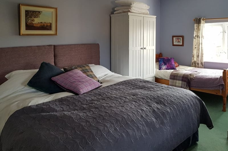Bedroom With Two Beds And White Wardrobe