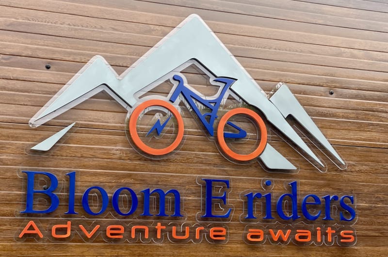 Bloom E Riders Sign With Bike And Mountain