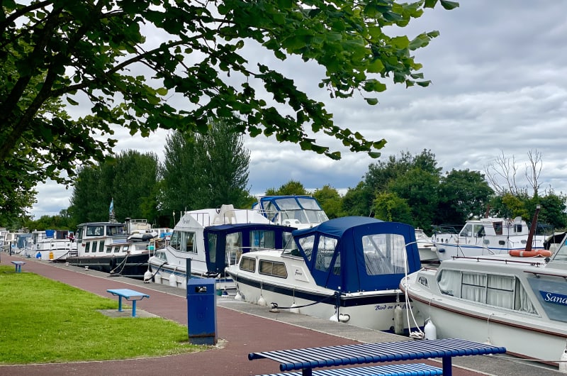 Boats Docked In A Marina By Benches