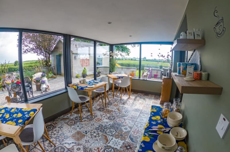 Bright sunroom breakfast area with patterned floor tiles