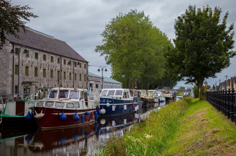Canal Boats Moored Beside Old Stone Building