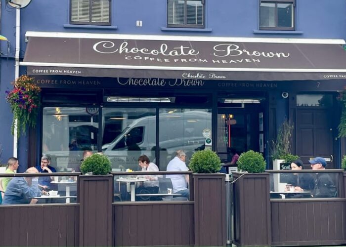 Chocolate Brown Coffee Shop Exterior With Patio Seating