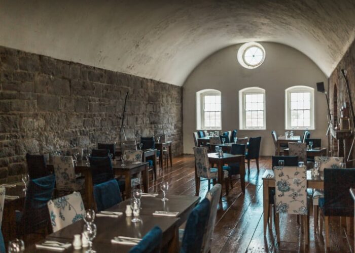 Dining room with vaulted ceiling and stone wall