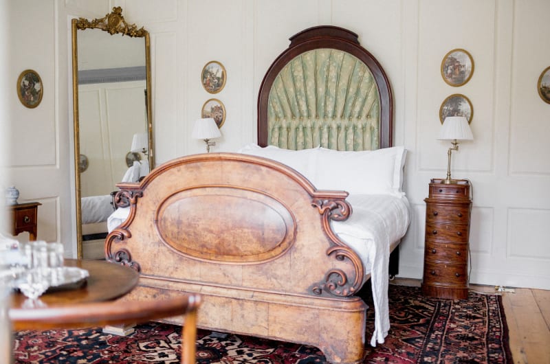 Elegant antique bedroom with ornate wooden bed