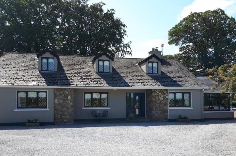 Front View Of Stone Guest House With Dormer