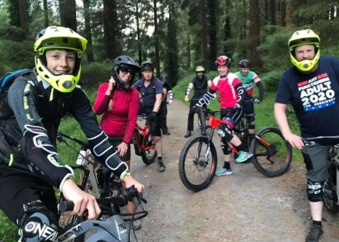 Group Of Mountain Bikers On A Forest Trail