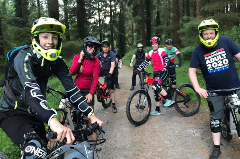 Group Of Mountain Bikers On A Forest Trail
