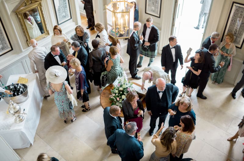 Guests In Formal Attire At Social Gathering