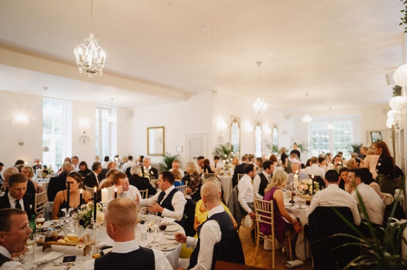Guests Seated At Tables During A Wedding Reception