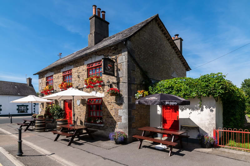 Hamiltons Pub Exterior With Red Windows And Seating