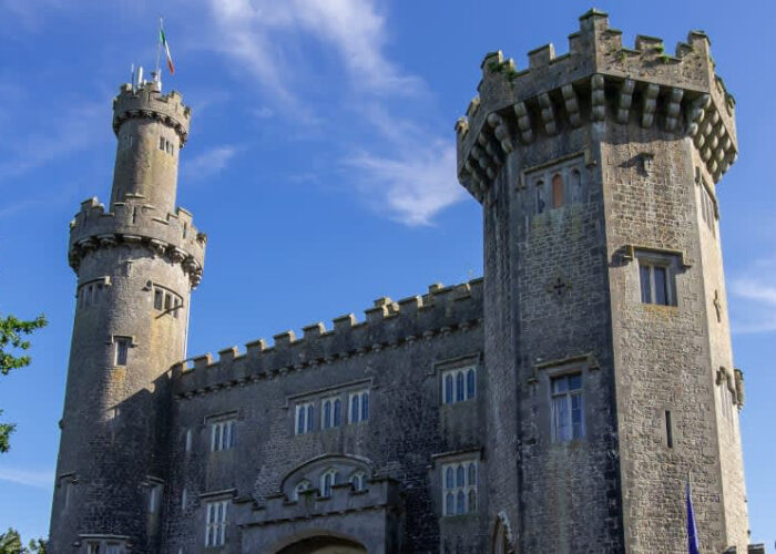 Historic Stone Castle With Towers Under Blue Sky