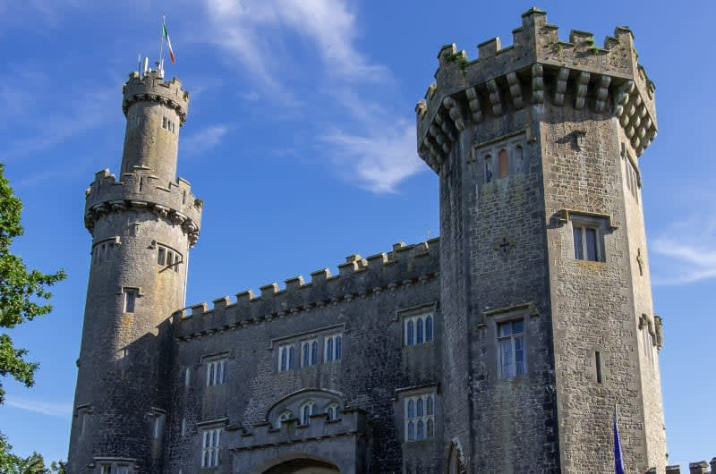 Historic Stone Castle With Towers Under Blue Sky