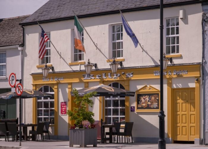 Kellys Pub Exterior Yellow Trim Outdoor Seating