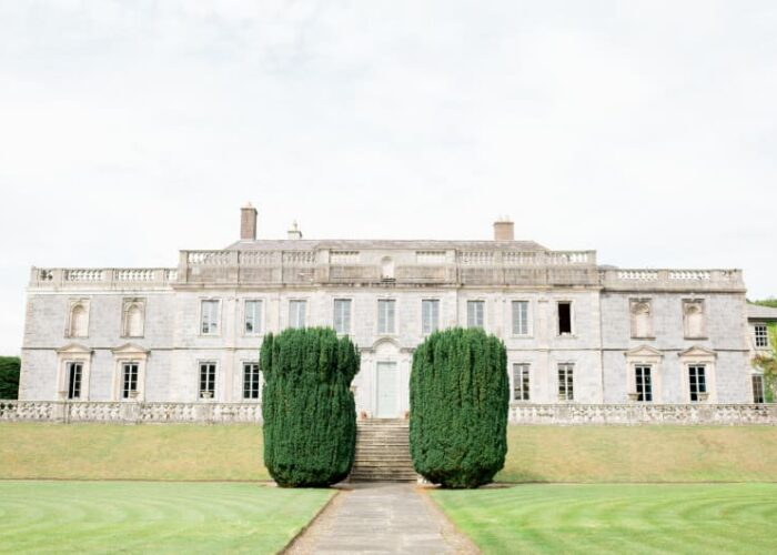 Large Stone Manor House With Manicured Green Lawn