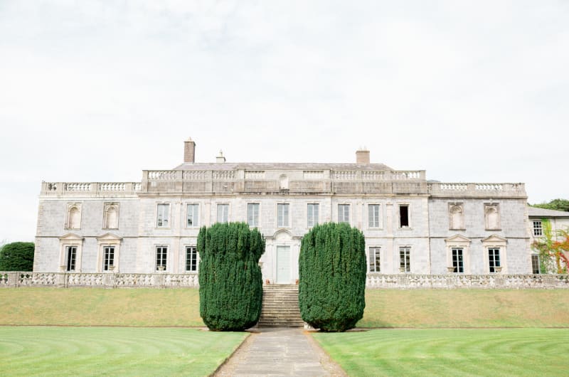 Large Stone Manor House With Manicured Green Lawn