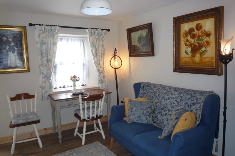 Living Room Interior With Blue Sofa And Paintings