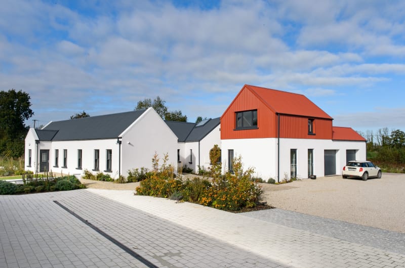 Modern White House With Red Corrugated Gabled Roof