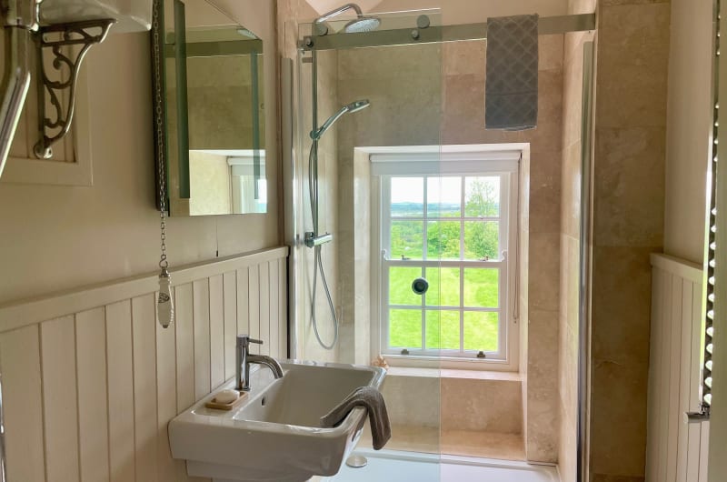 Modern bathroom with sink shower and scenic view