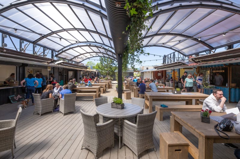 Outdoor Food Court With Tables Under Translucent Canopy