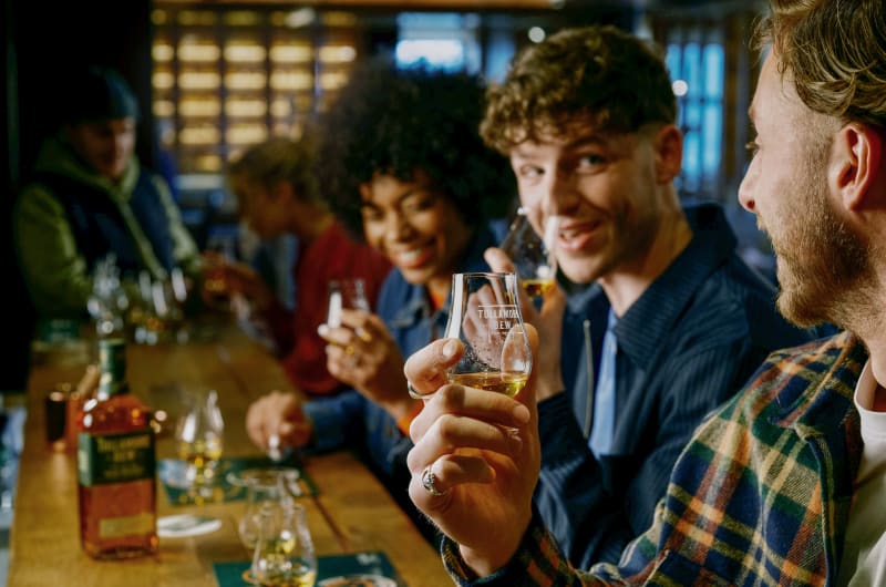 People tasting Tullamore DEW whiskey at a bar
