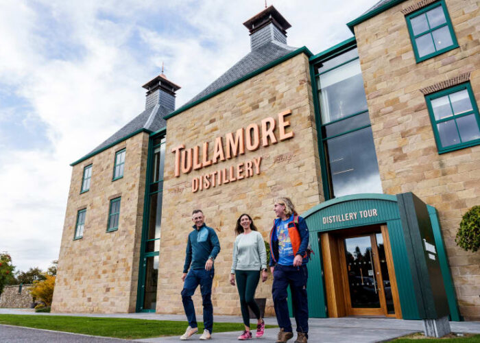 People walking outside the Tullamore Distillery building