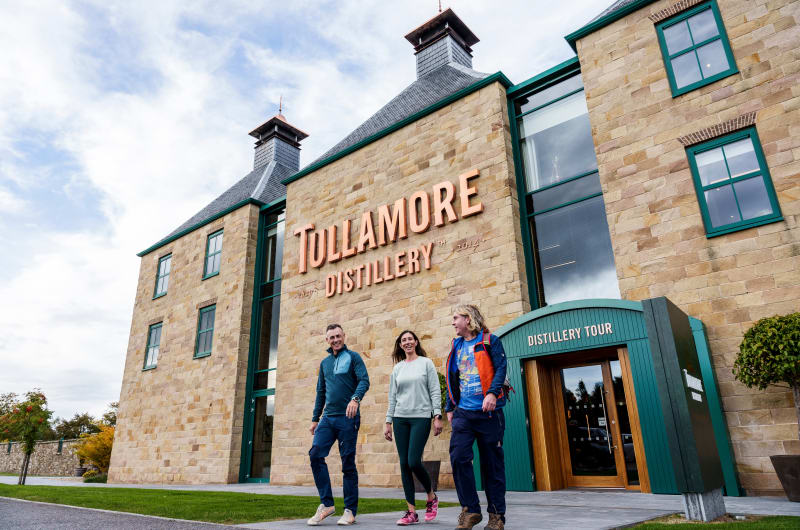 People walking outside the Tullamore Distillery building