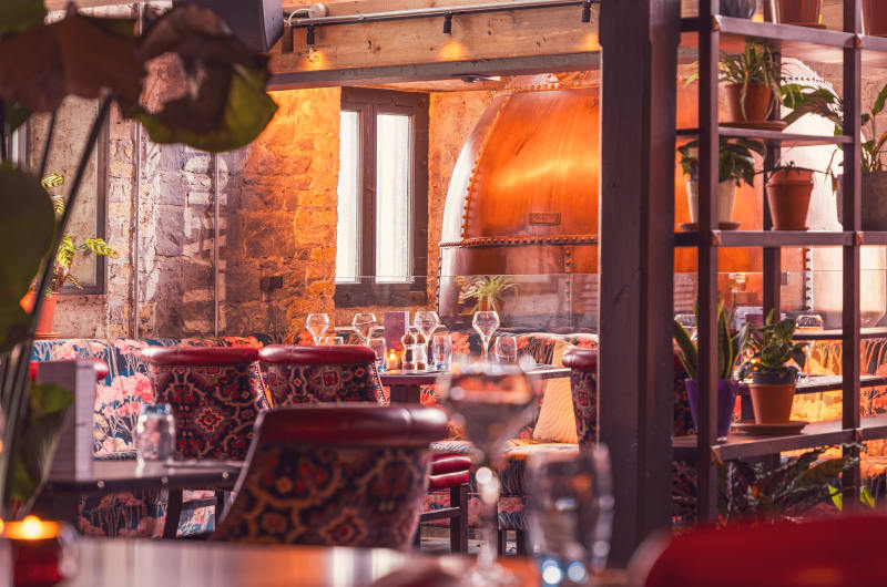 Restaurant Dining Area With Large Copper Still