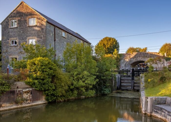 Stone building next to canal lock and bridge