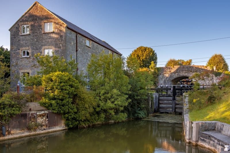 Stone building next to canal lock and bridge