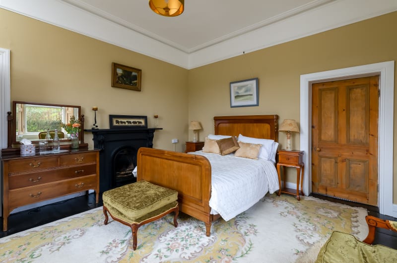 Traditional country house bedroom with wooden bed