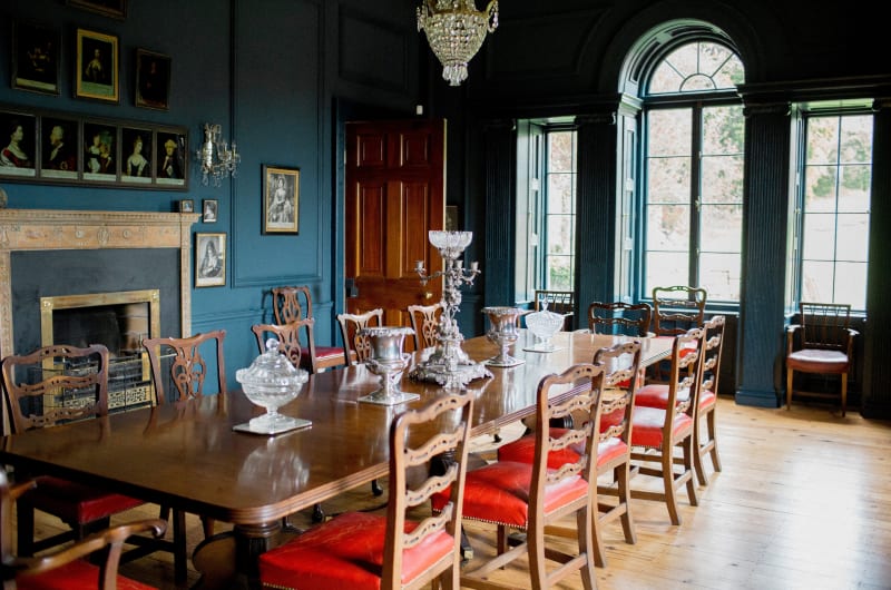 Traditional dining room with large table and portraits
