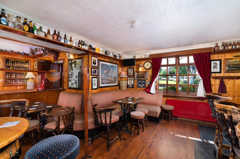 Traditional pub interior with wooden walls and seating