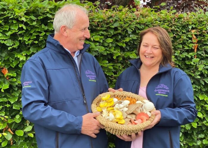 Two People Holding Basket Of Garryhinch Wood Mushrooms