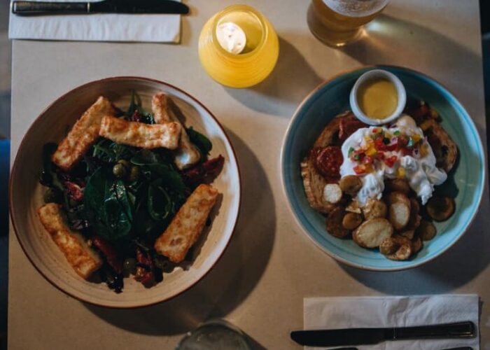 Two plates of food and drinks on table