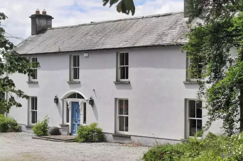 White House With Blue Door And Gravel Drive