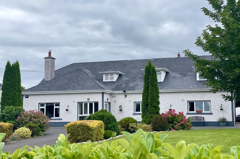 White House With Landscaped Garden And Cloudy Sky