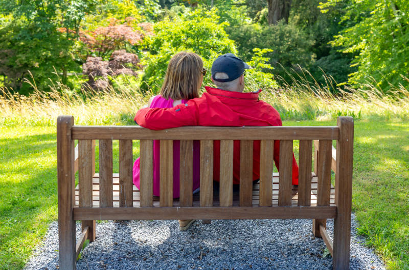 couple sitting on wooden garden bench