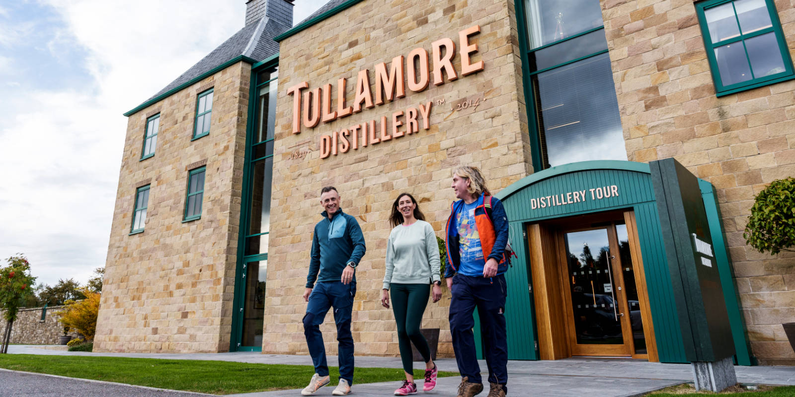 header three young adults outside tullamore distillery