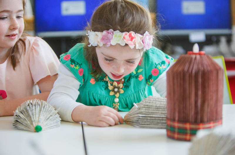 two girls making paper art