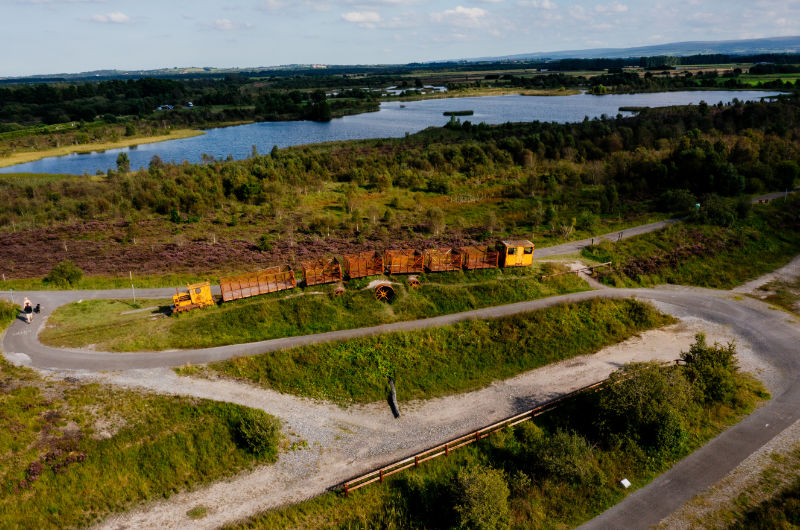Aerial view of yellow peat train at Lough Boora