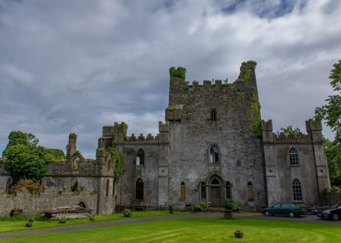 Ancient stone castle ruins with ivy and lawn ily2yh