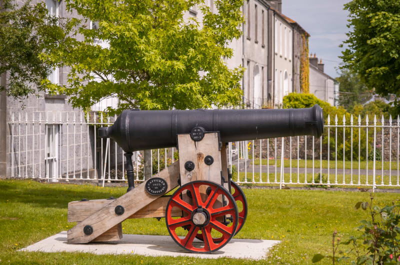 Black cannon on wooden carriage with red wheels gfvwkm