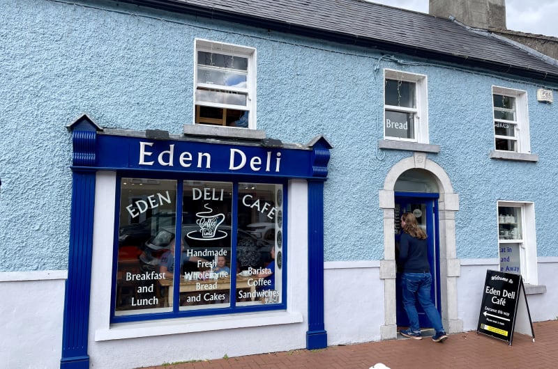 Blue Eden Deli Storefront With Person Entering okg3dt