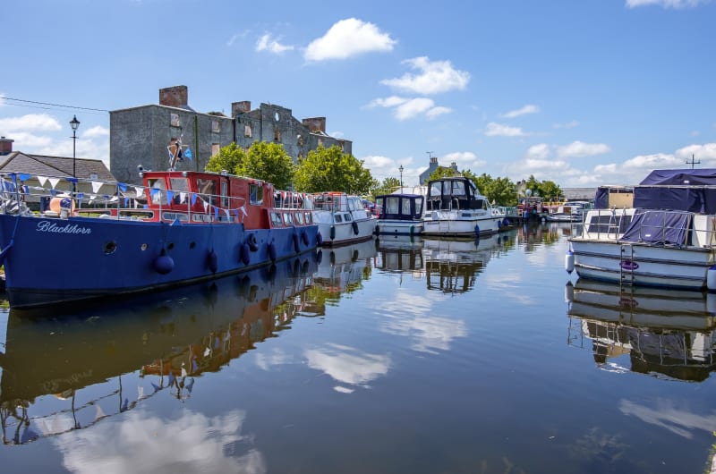Canal Boats Docked Near A Derelict Stone Building l7lkev