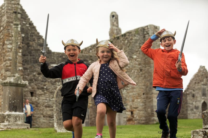 Children Wearing Viking Helmets Playing At Clonmacnoise Ruins