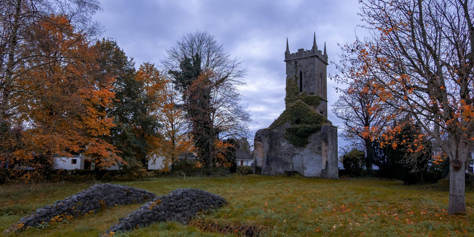 Daingean Header Image Ruined Stone Church Tower Surrounded By Autumn Trees