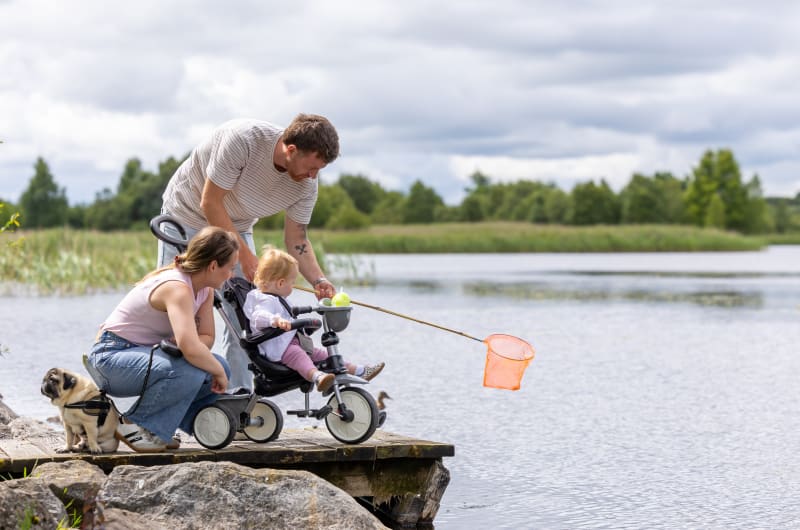 Family With Toddler And Dog Fishing By Lake kvydze