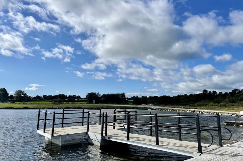 Floating Dock On Water Under Cloudy Blue Sky rr0vra